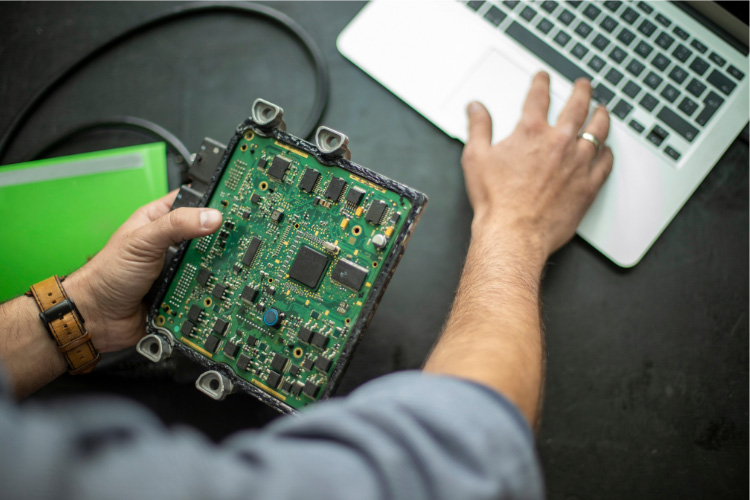 Man tuning a car ECU on a laptop